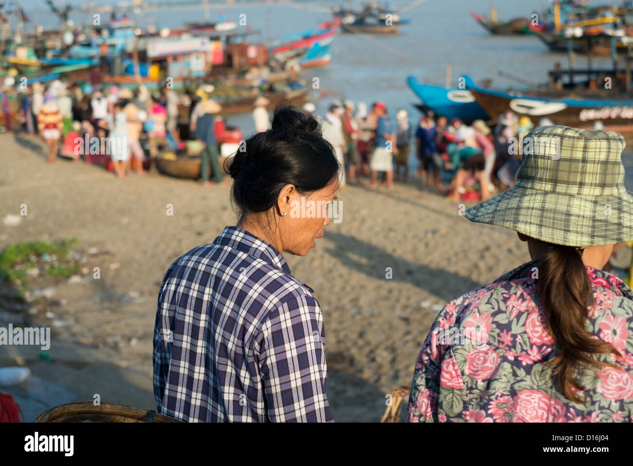 General view shot of fishing harbor early in the morning with the frenzied activity of the locals Stock Photo