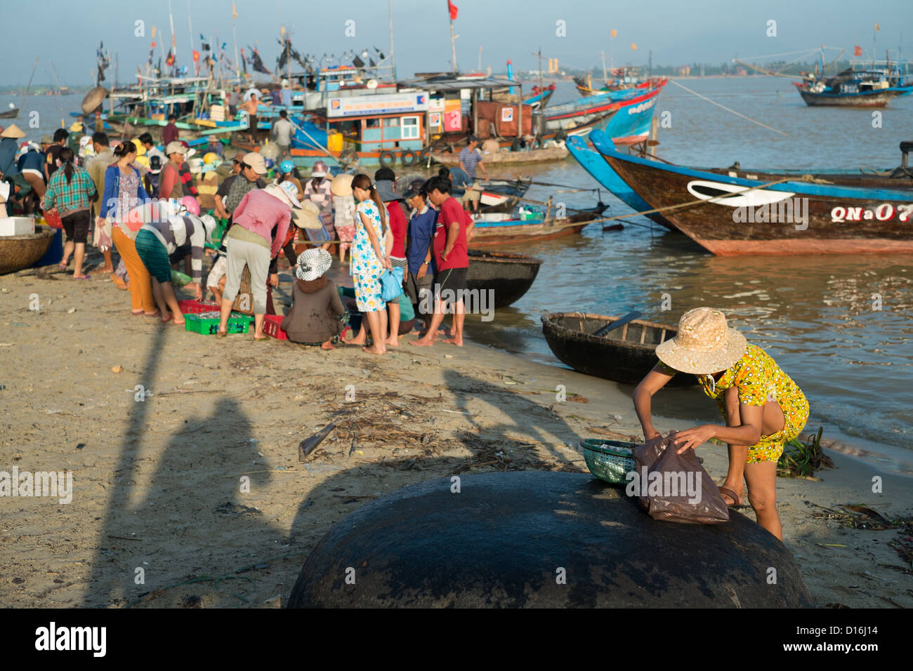 General view shot of fishing harbor early in the morning with the frenzied activity of the locals Stock Photo