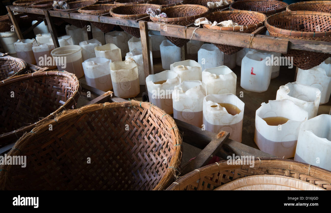 plastic containers being filled with fish sauce Stock Photo