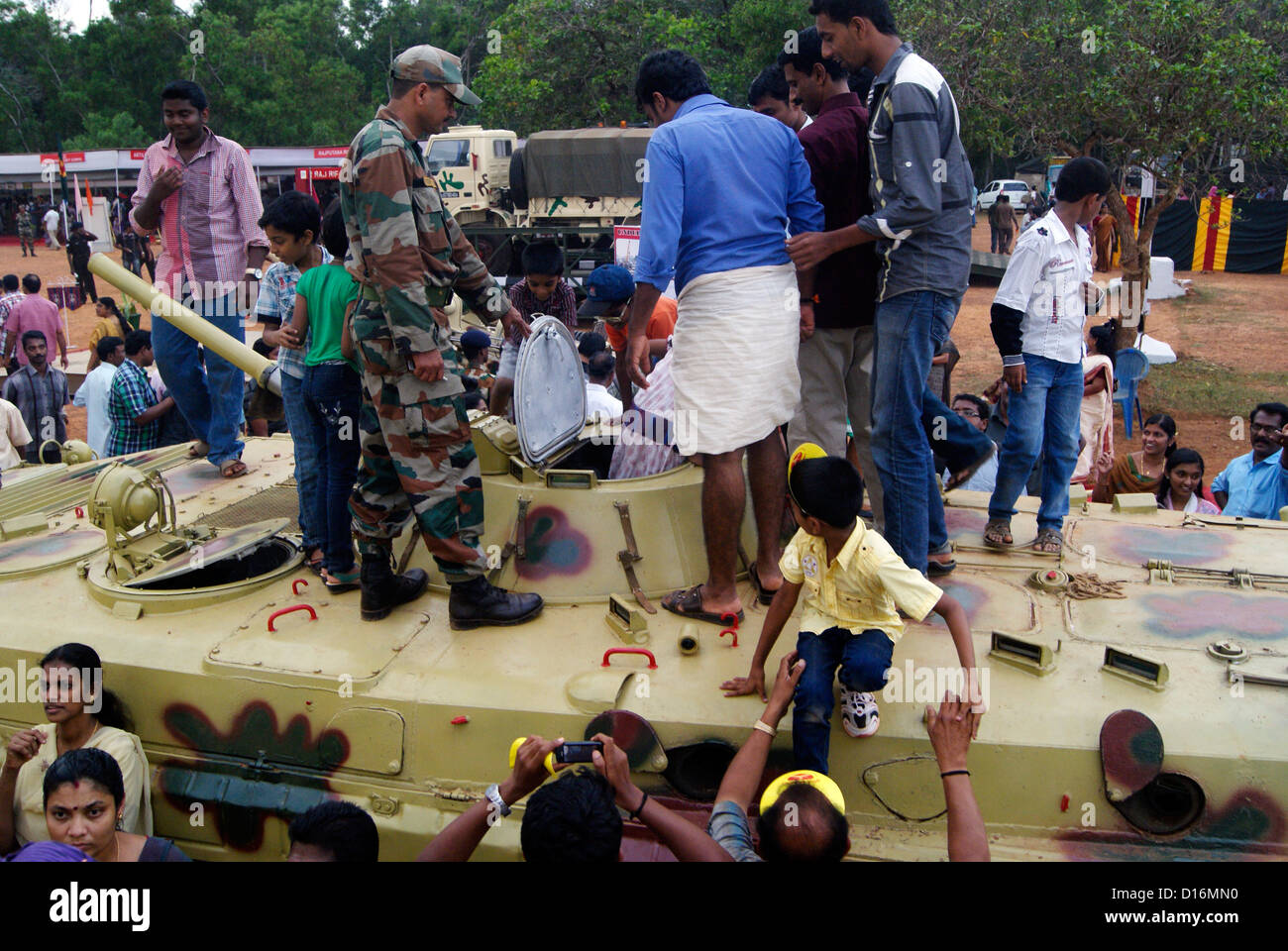 Civilians enjoy watching and entering into the Indian Military T 72 Army Tank demonstrated by India Army Soldier Stock Photo