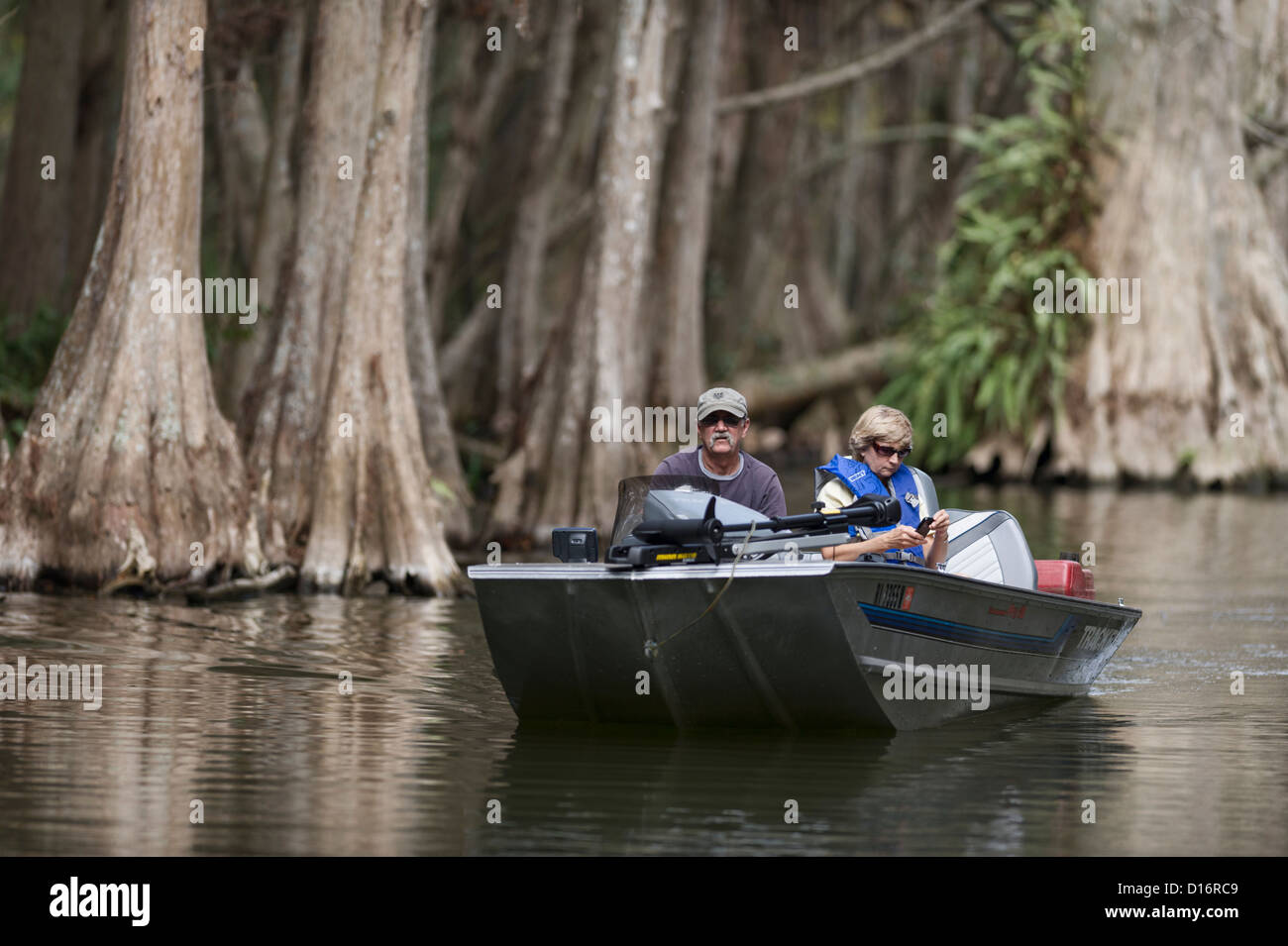 A couple boating among the cypress trees on the Mount Dora Canal in