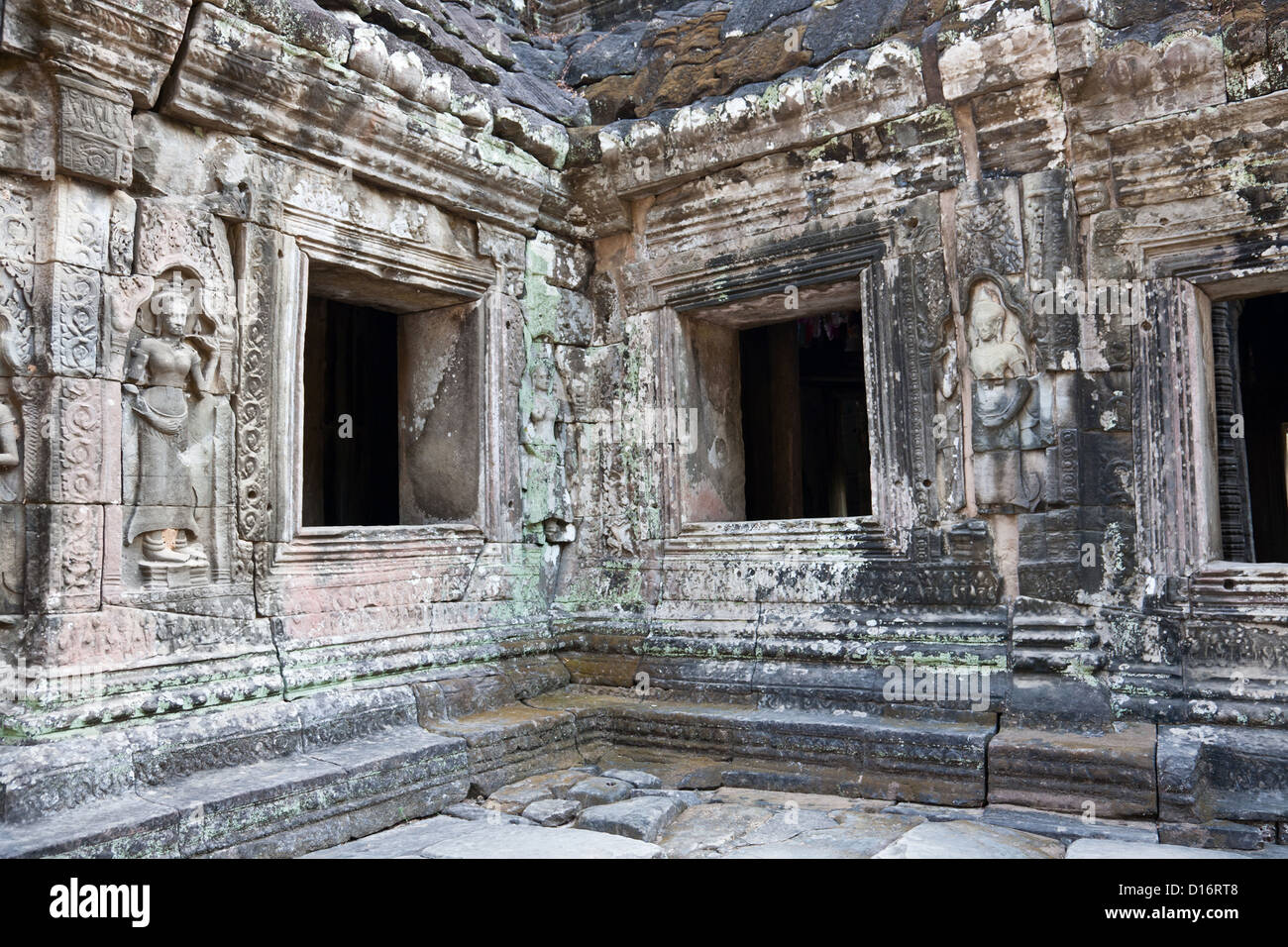 Almost ruined temple with buddha carving on the wall, Angkor wat, Cambodia Stock Photo