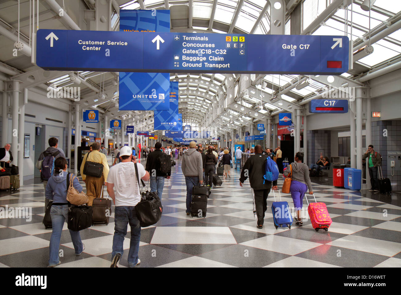 Chicago Illinois,O'Hare International Airport,ORD,gate,terminal,passenger passengers rider riders,luggage,suitcase,sign,logo,information,directions,si Stock Photo