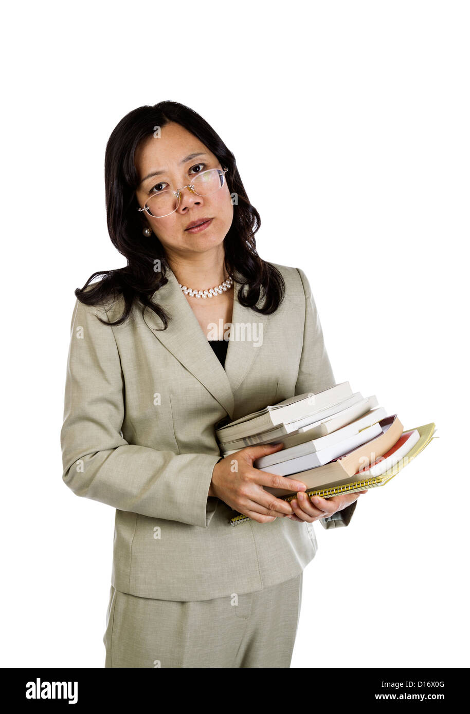 Mature Asian Woman being over worked holding stack of books on white background Stock Photo