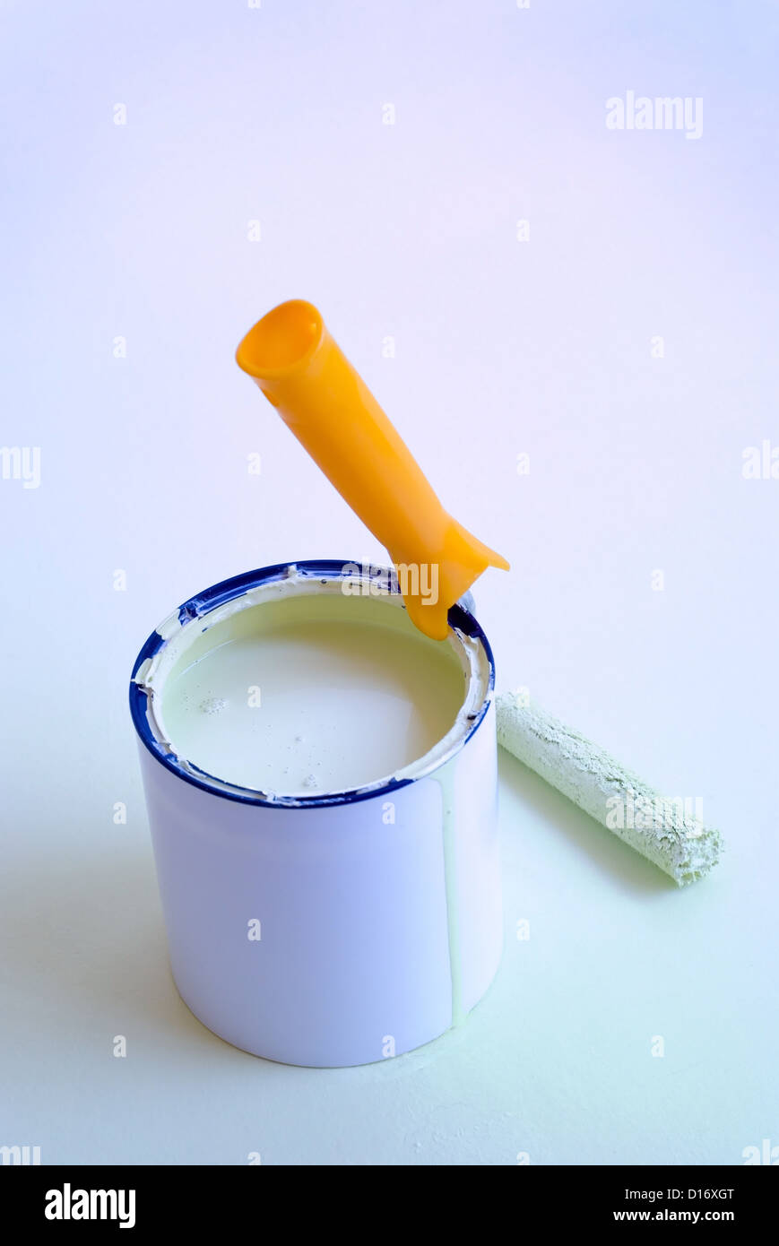 Home improvement painting roller resting on paint tin container Stock