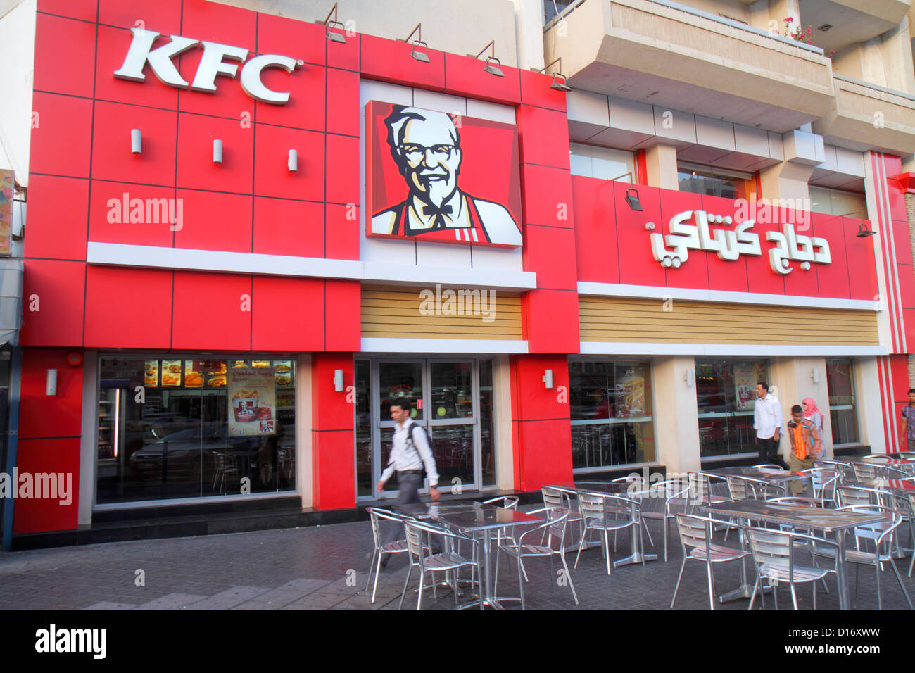 Dubai UAE,United Arab Emirates,Deira,Al Rigga,Al Rigga Road,English,Arabic,language,bilingual,small businesses,district,street scene,KFC,fast food,res Stock Photo