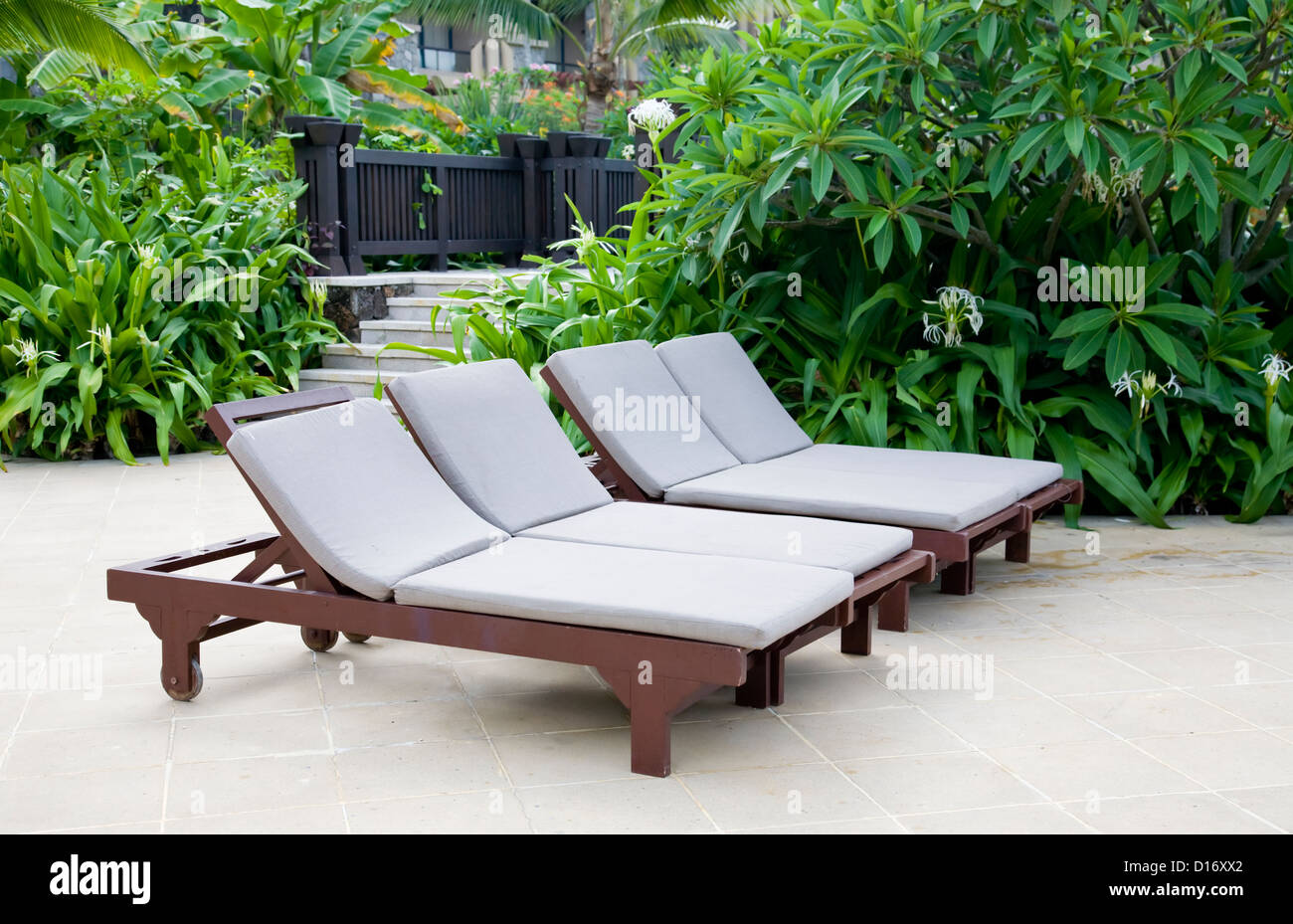 Lounge chairs in summer garden Stock Photo Alamy