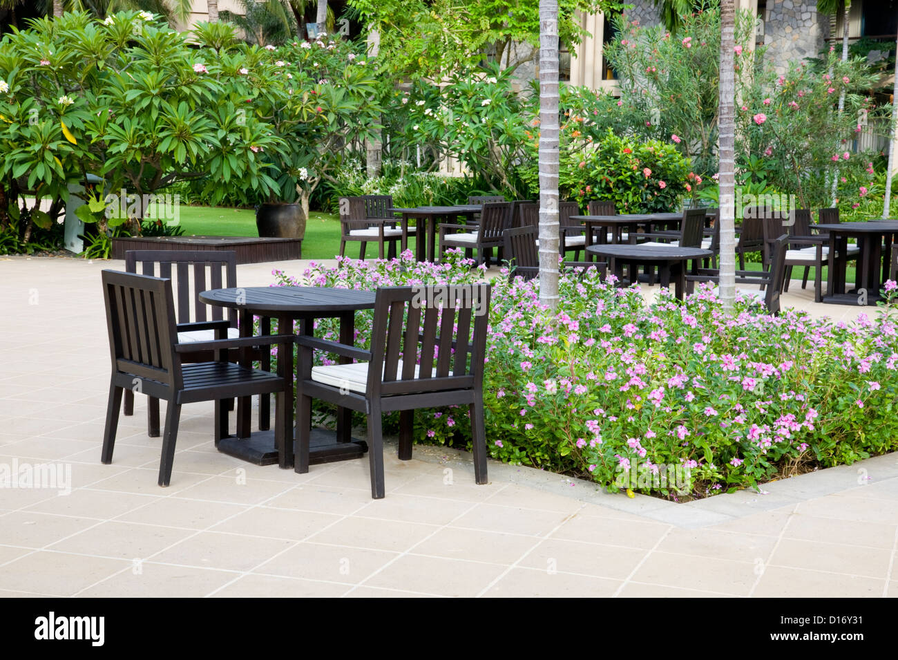 Patio with table and chairs in hotel backyard. Stock Photo