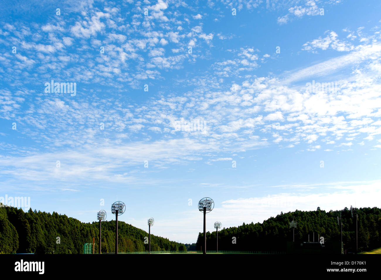 Baseball field lighting system and blue sky with clouds Stock Photo - Alamy