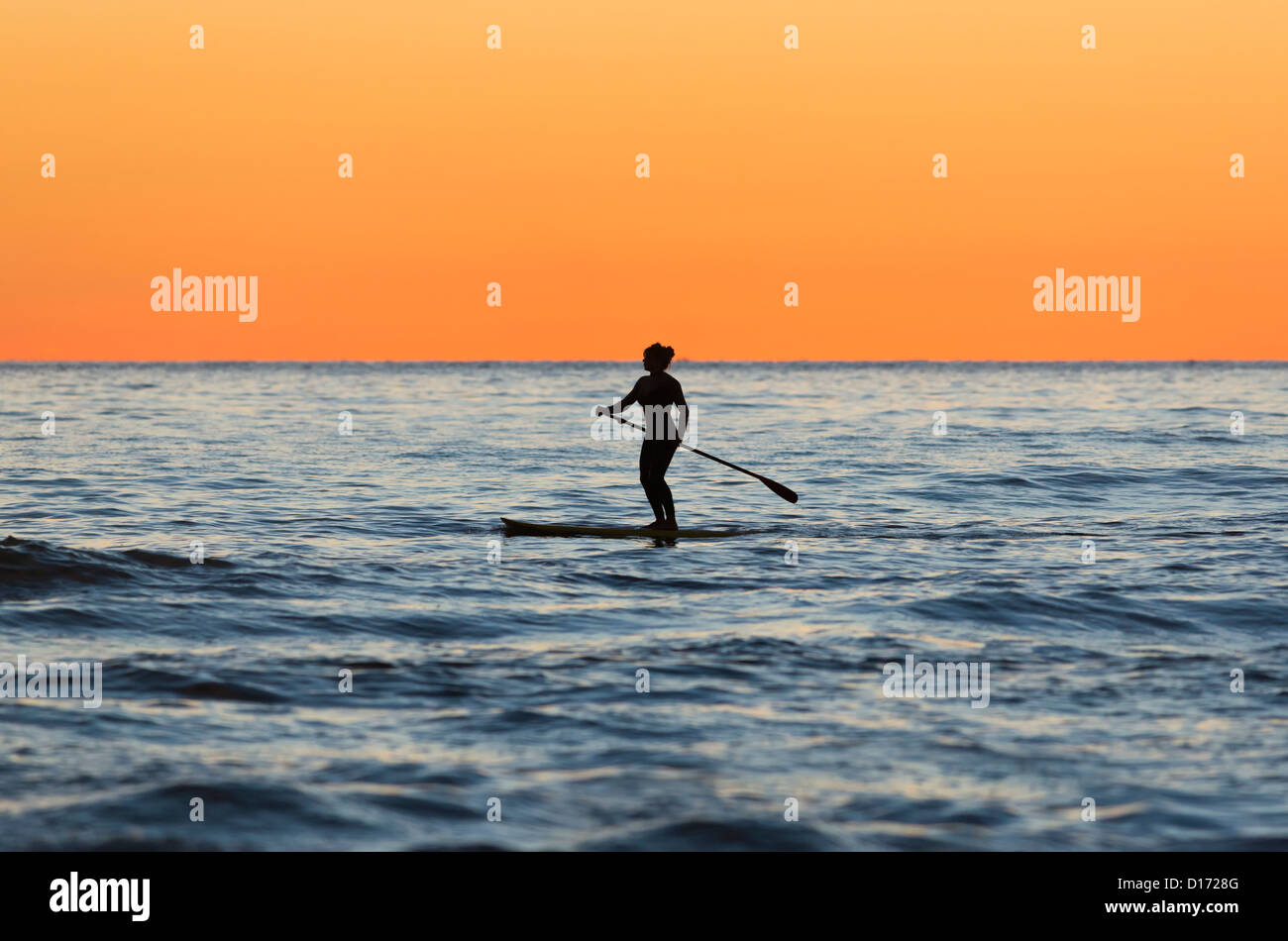 Woman doing stand up paddle surf. Tarifa, Costa de la Luz, Cadiz