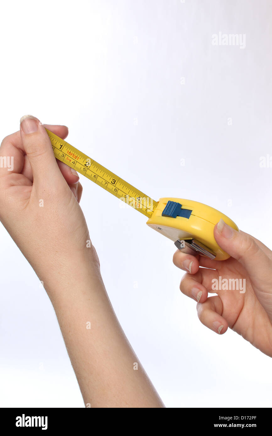 close up of a hand holding a tape measure Stock Photo