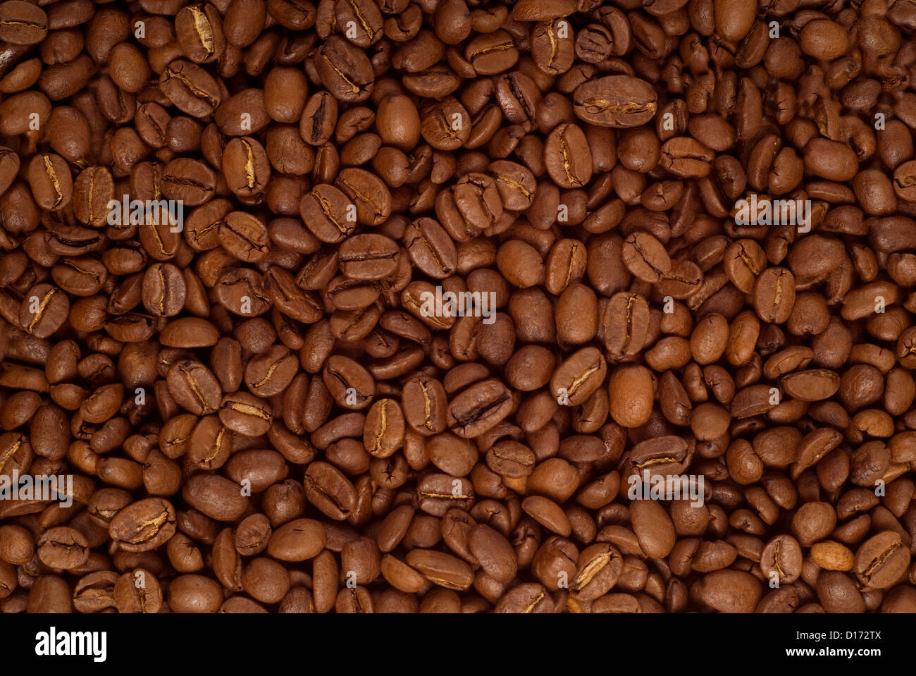 Roasted brown coffee beans as a background Stock Photo - Alamy