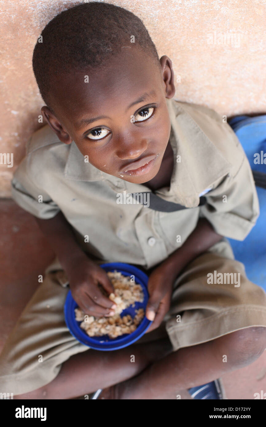 Child eating a meal in a primary school in Africa Stock Photo