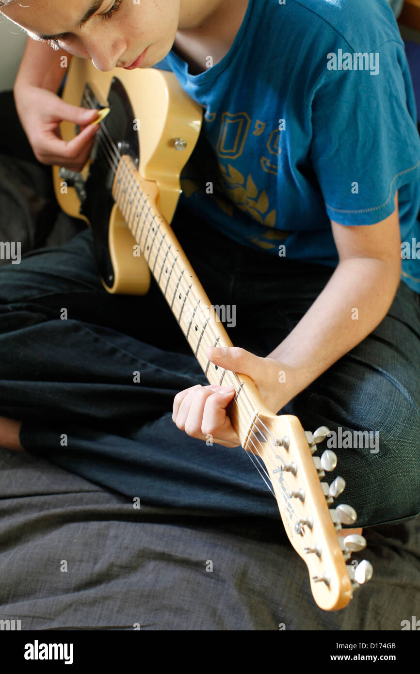 Teenager playing a guitar Stock Photo Alamy