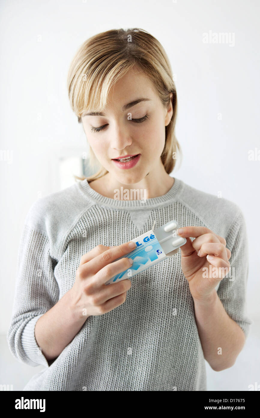 WOMAN TAKING GENERIC DRUG Stock Photo