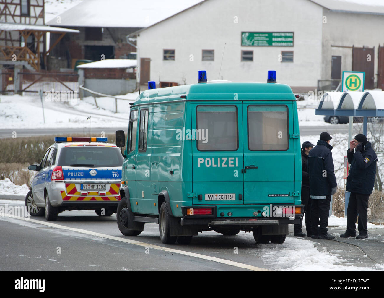 Police officers of the Hesse State Office of Criminal Investigations (LKA) preserve traces and look for bullets after a deadly shooting in a street in Kolmbach, Germany, 07 December 2012. In the early hours of 07 December, a man had wandered the B47 road with a loaded gun and threatened to kill himself. In a shootout with the police the man had been killed. Photo: Boris Roessler Stock Photo