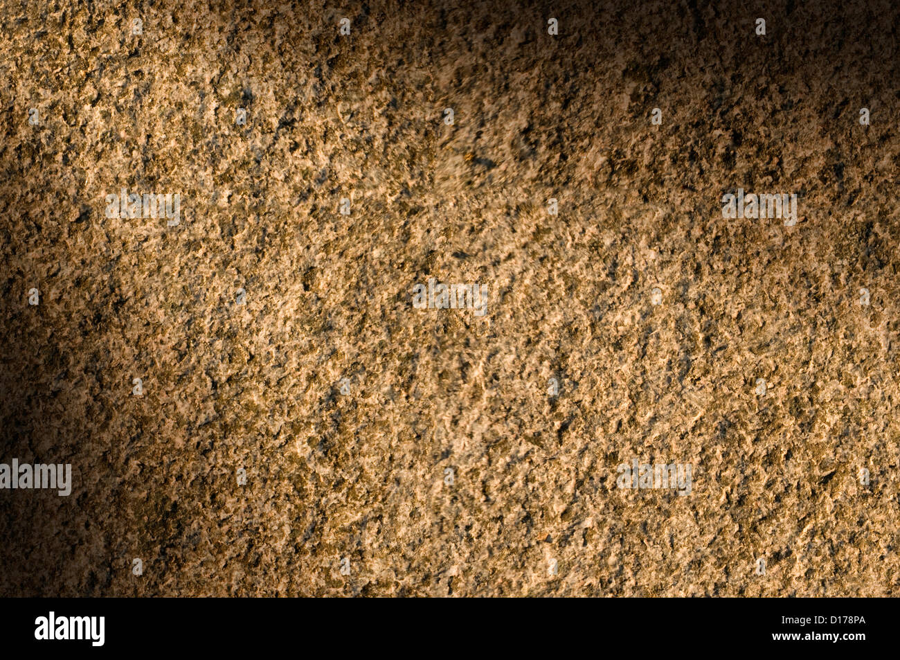 Granite rock stone background texture lit diagonally Stock Photo
