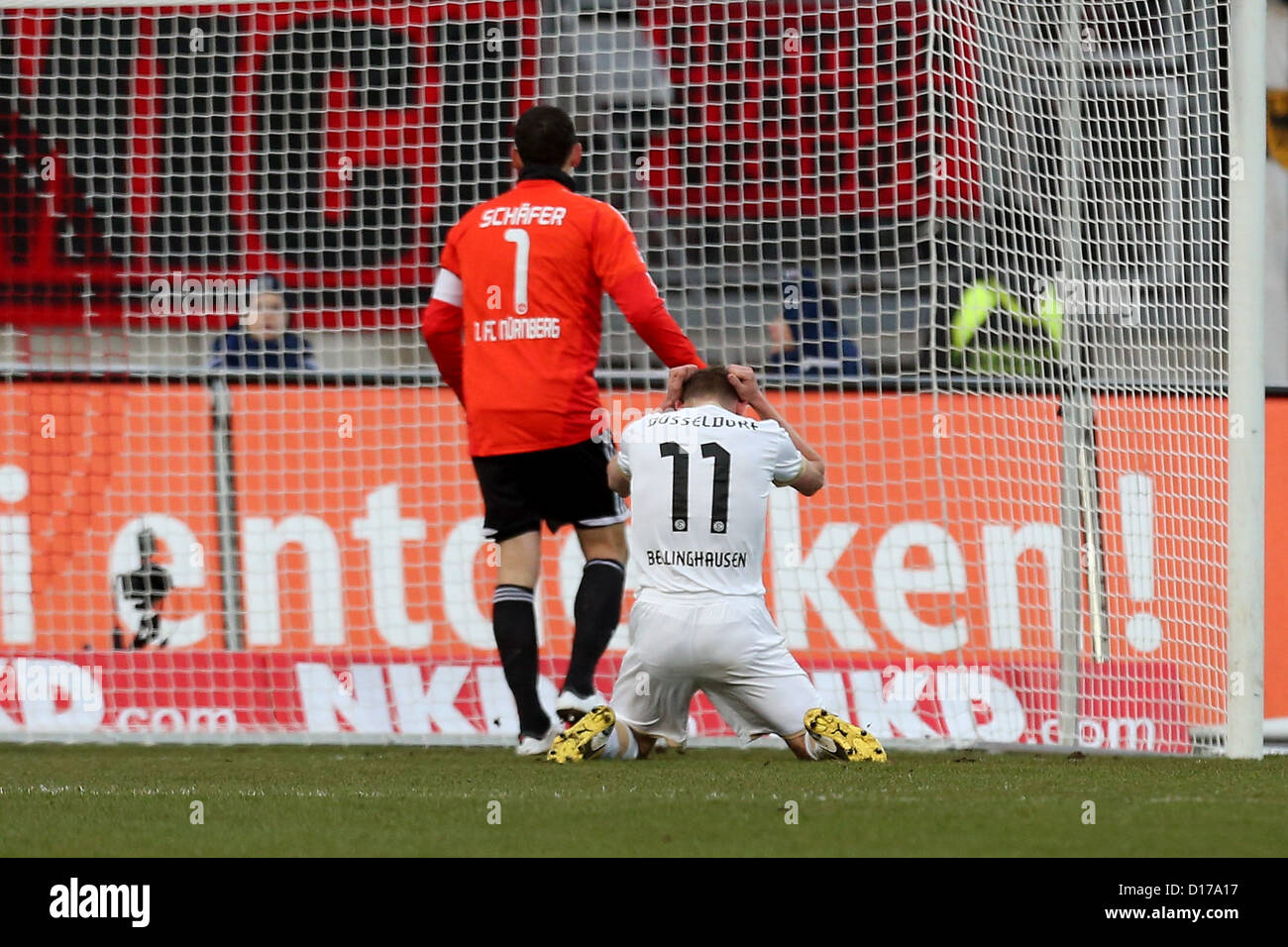 Nuremberg's goalkeeper Raphael Schaefer (L) stands next Duesseldorf's Axel Bellinghausen who reacts missed scoring opportunity during Bundesliga soccer match between FC Nuremberg Fortuna Duesseldorf Nuremberg Stadium in Nuremberg Germany 08 December 2012 Photo: DANIEL KARMANN (ATTENTION: EMBARGO CONDITIONS! DFL permits further utilisation up 15 pictures only (no sequntial pictures or video-similar series pictures allowed) via internet online media during match (including halftime) taken inside stadium and/or prior start match DFL permits unrestricted transmission digitised recordings during Stock Photo
