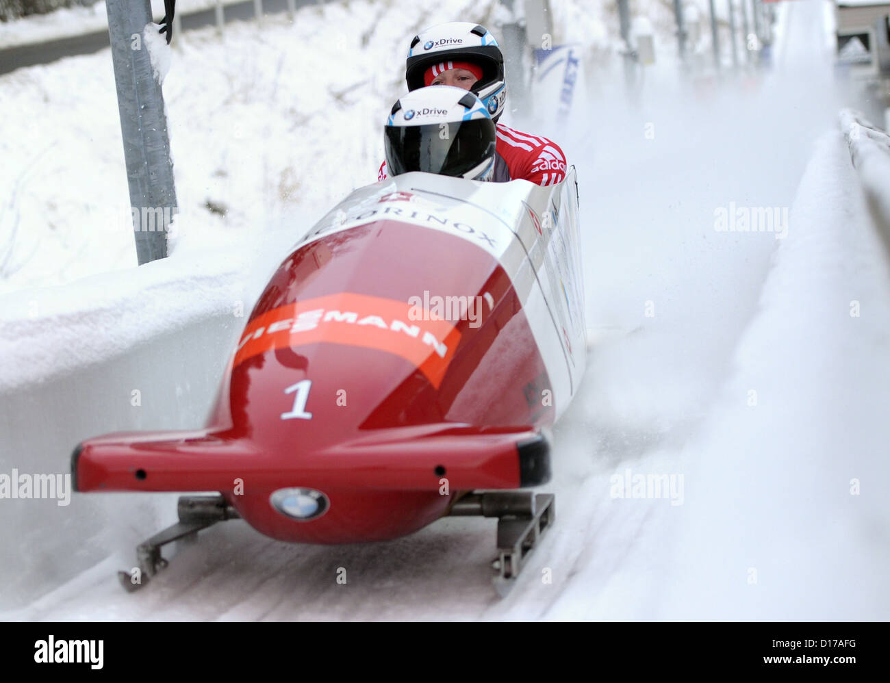 Swiss bobsleigh Beat Hefti (R) and Thomas Lamparter race in the 2012 FIBT tow-person bobsleigh world cup in Winterberg, Germany, 08 December 2012. They came in first place Photo: DANIEL NAUPOLD Stock Photo