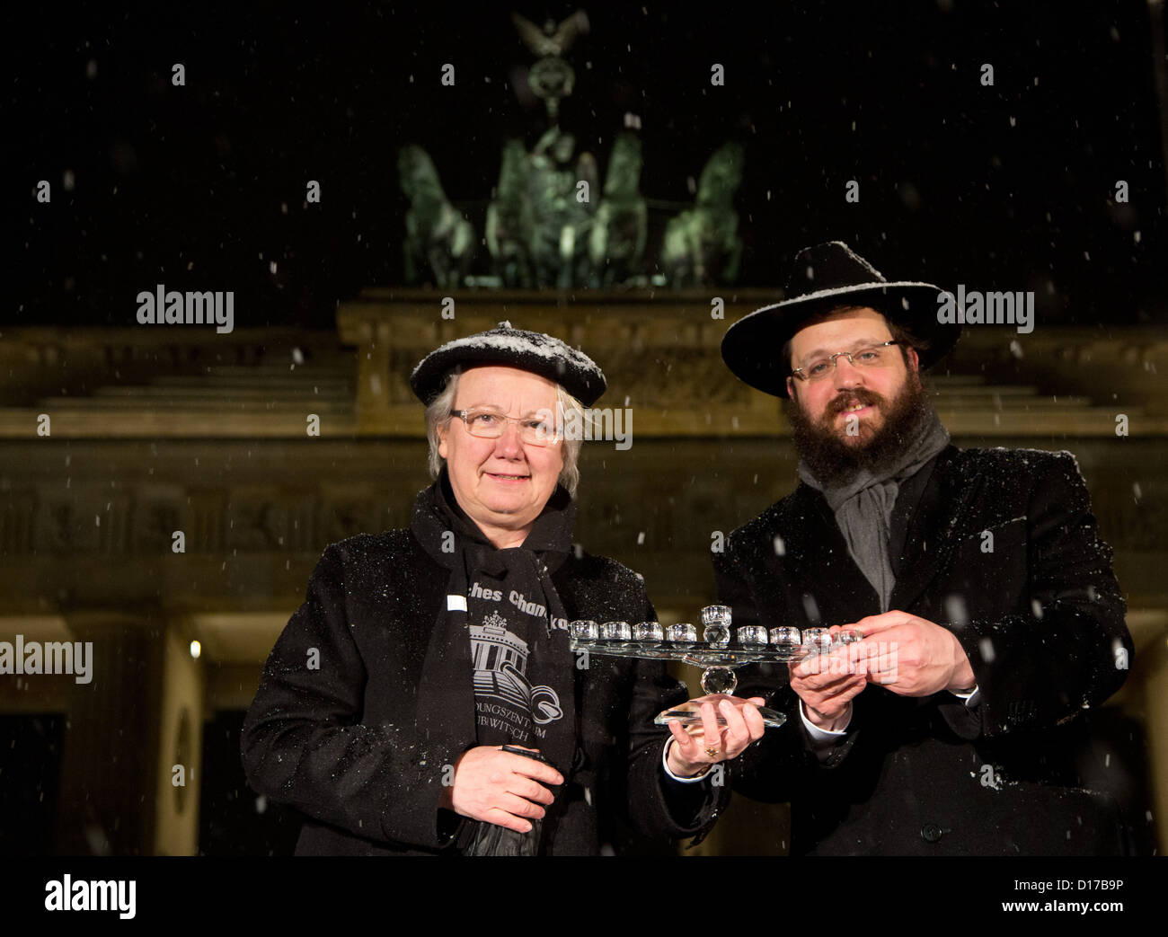 German Education and Research Minister Annette Schavan and rabbi Yehuda Teichtal hold a Hanukkah candelabrum at the Brandenburg Gate in Berlin, Germany, 09 december 2012. The Jewish holiday commemorates the rededication of the Holy Temple in Jerusalem in the 2nd century BCE. Photo: JOERG CARSTENSEN Stock Photo