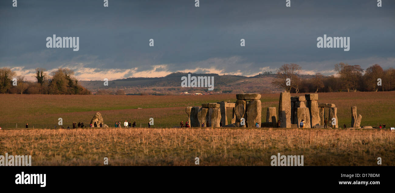 Stonehenge on Salisbury Plain is a prehistoric monument located in the English county of Wiltshire. Heel stone on far left. Stock Photo