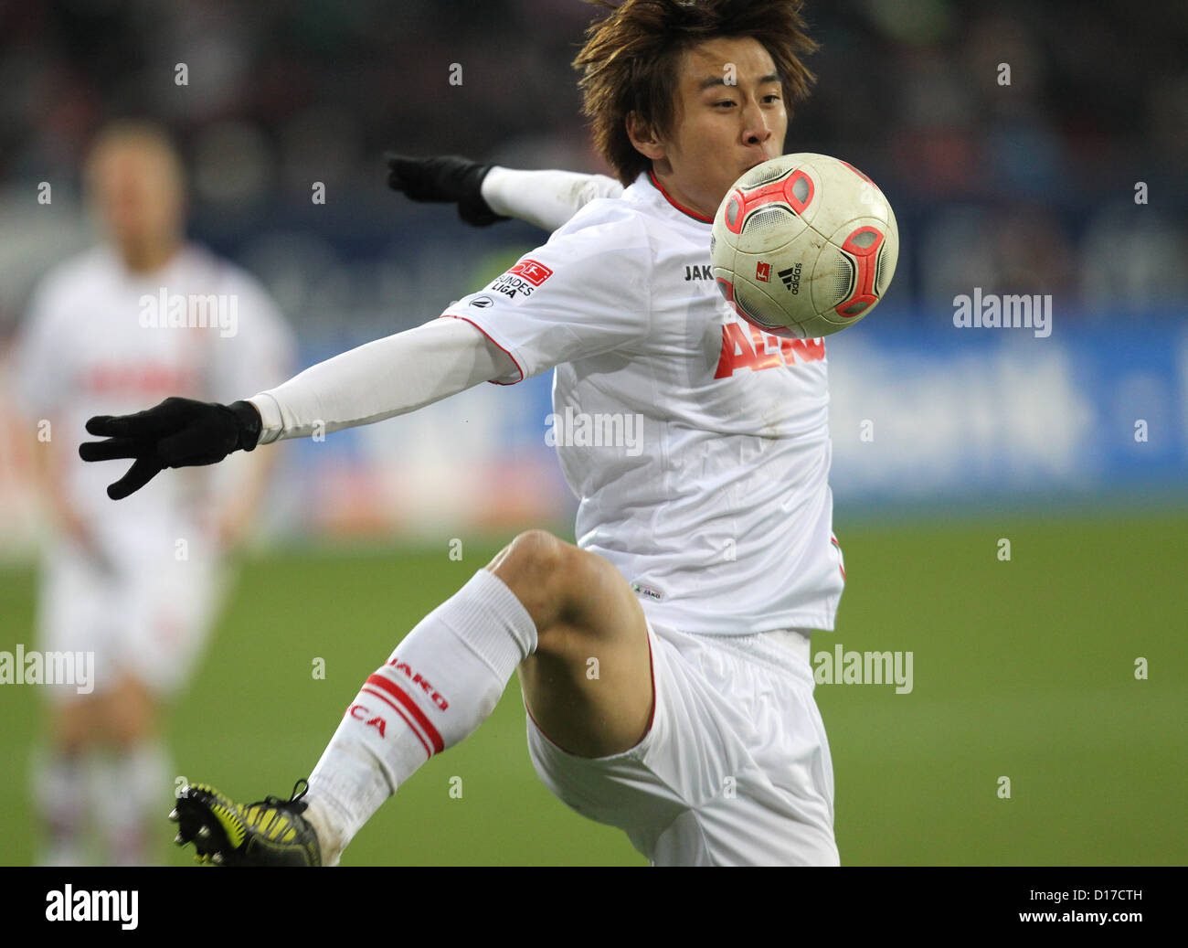 Augsburg's Ja-Cheol Koo plays the ball during the German Bundesliga match between FC Augsburg and FC Bayern Munich at SGL-Arena in Augsburg, germany, 08 December 2012. Photo: Karl-Josef Hildenbrand Stock Photo