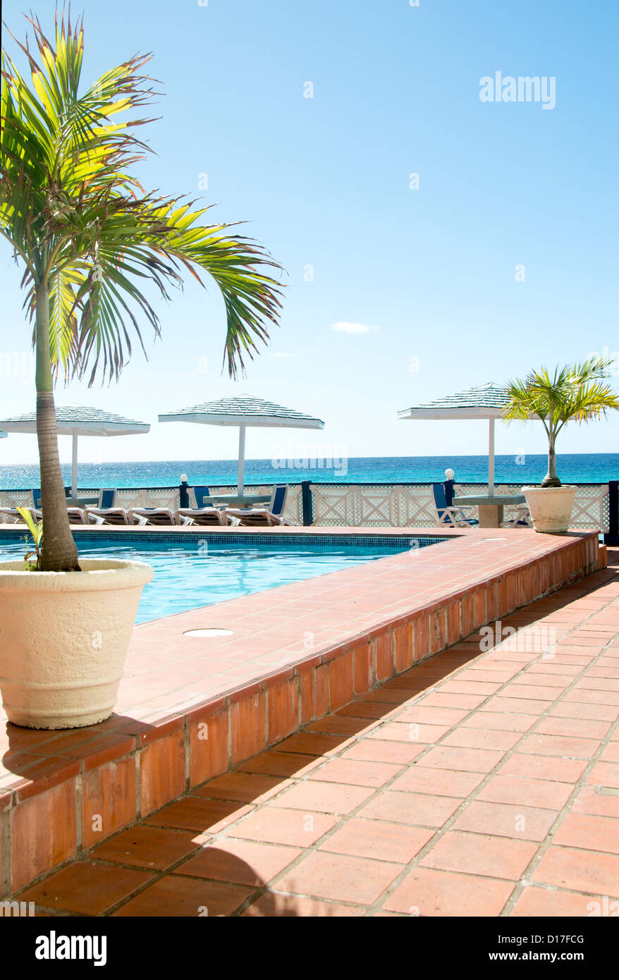 hotel swimming pool lounge chaise chairs over Caribbean Sea St
