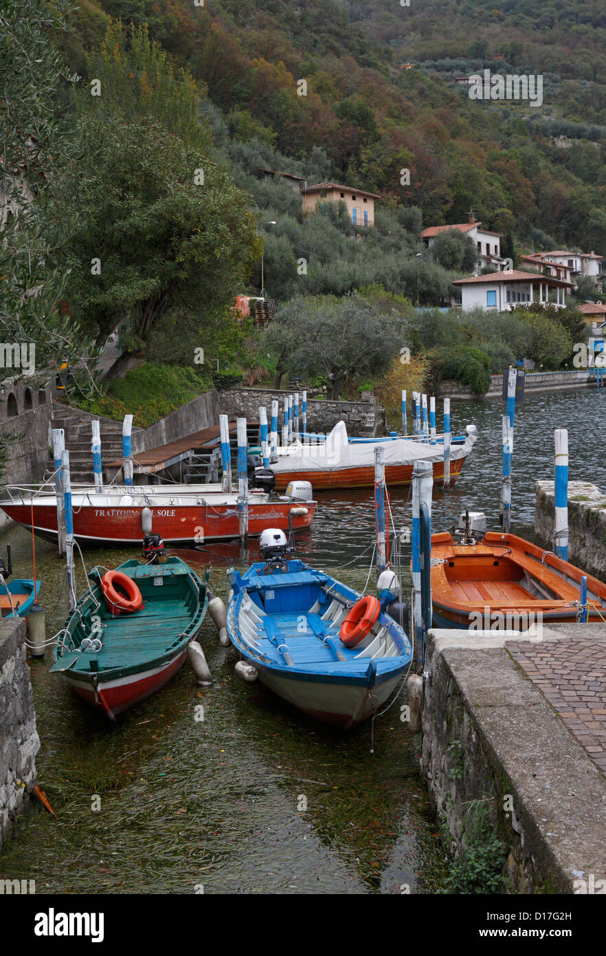 Boats in a small harbour in Monte Isola on Lake Iseo near Bergamo, Lombardy, Italy, Europe. Stock Photo