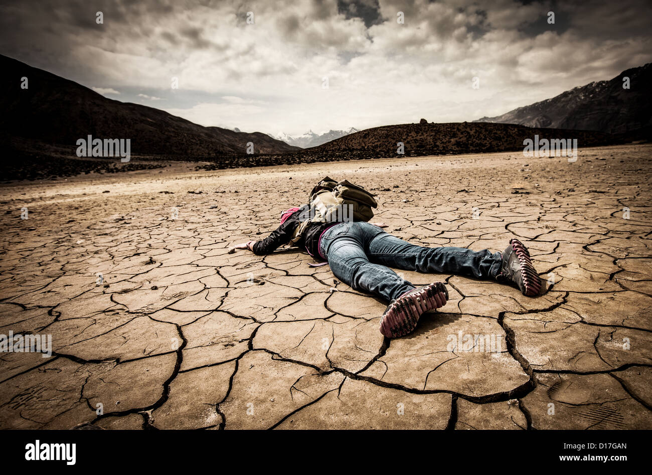 traveller lays on the dried ground Stock Photo