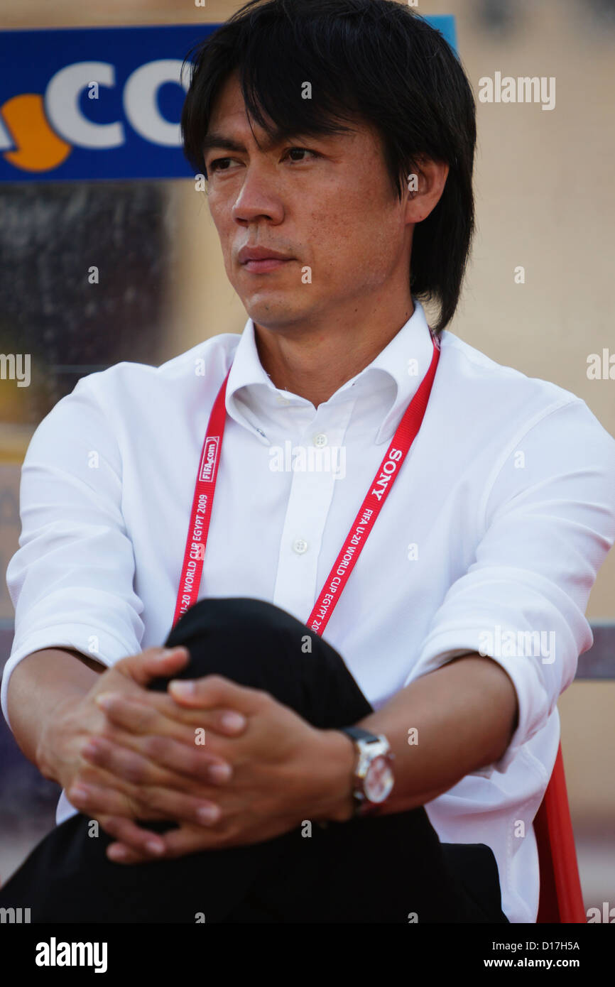 South Korea Head Coach Myung Bo Hong sits on the team bench before kick