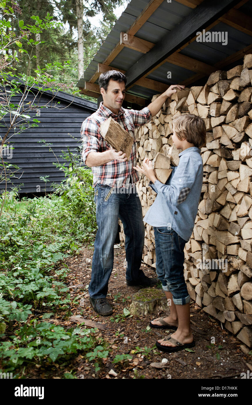 Father and son getting firewood outdoors Stock Photo - Alamy