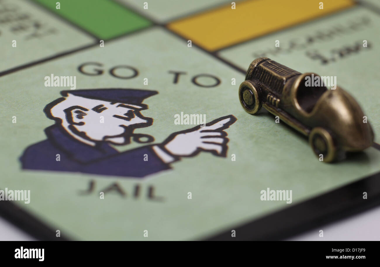 Go To Jail square on a Monopoly board with car players piece. Stock Photo