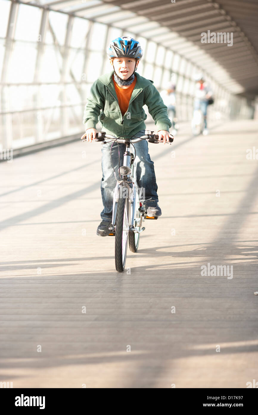 Boy riding bicycle in city tunnel Stock Photo