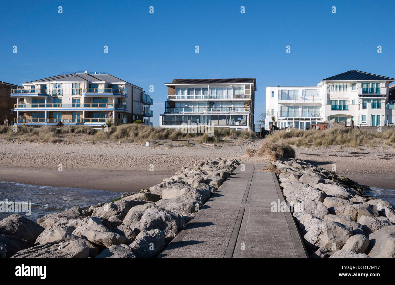 View of luxury apartments from a groyne on Sandbanks beach, Poole Bay