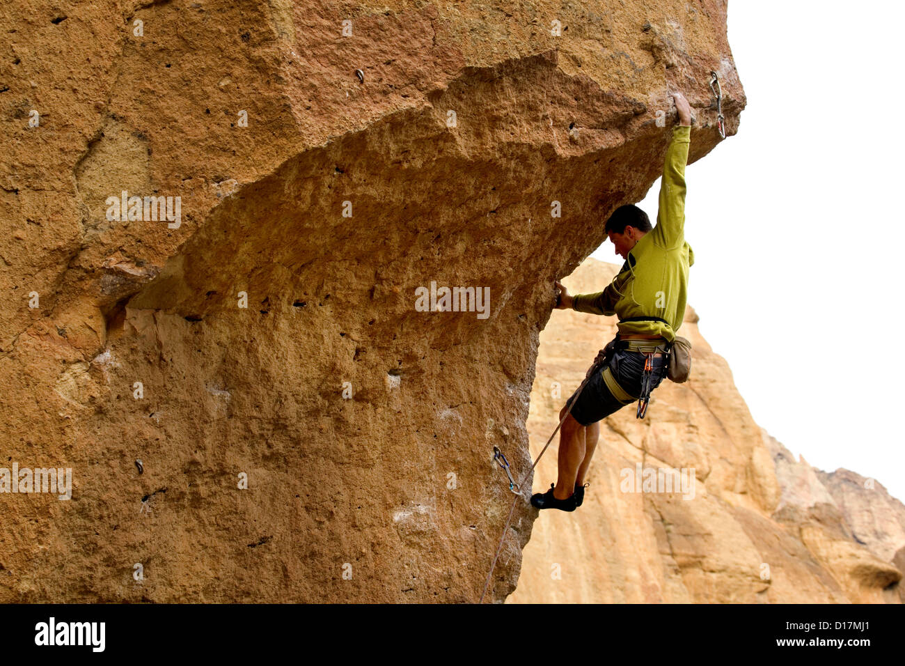 OR00598-00....OREGON - Rock climber Ulli Viertler ascending an overhang on the Chain Reaction route at Smith Rocks State Park. Stock Photo