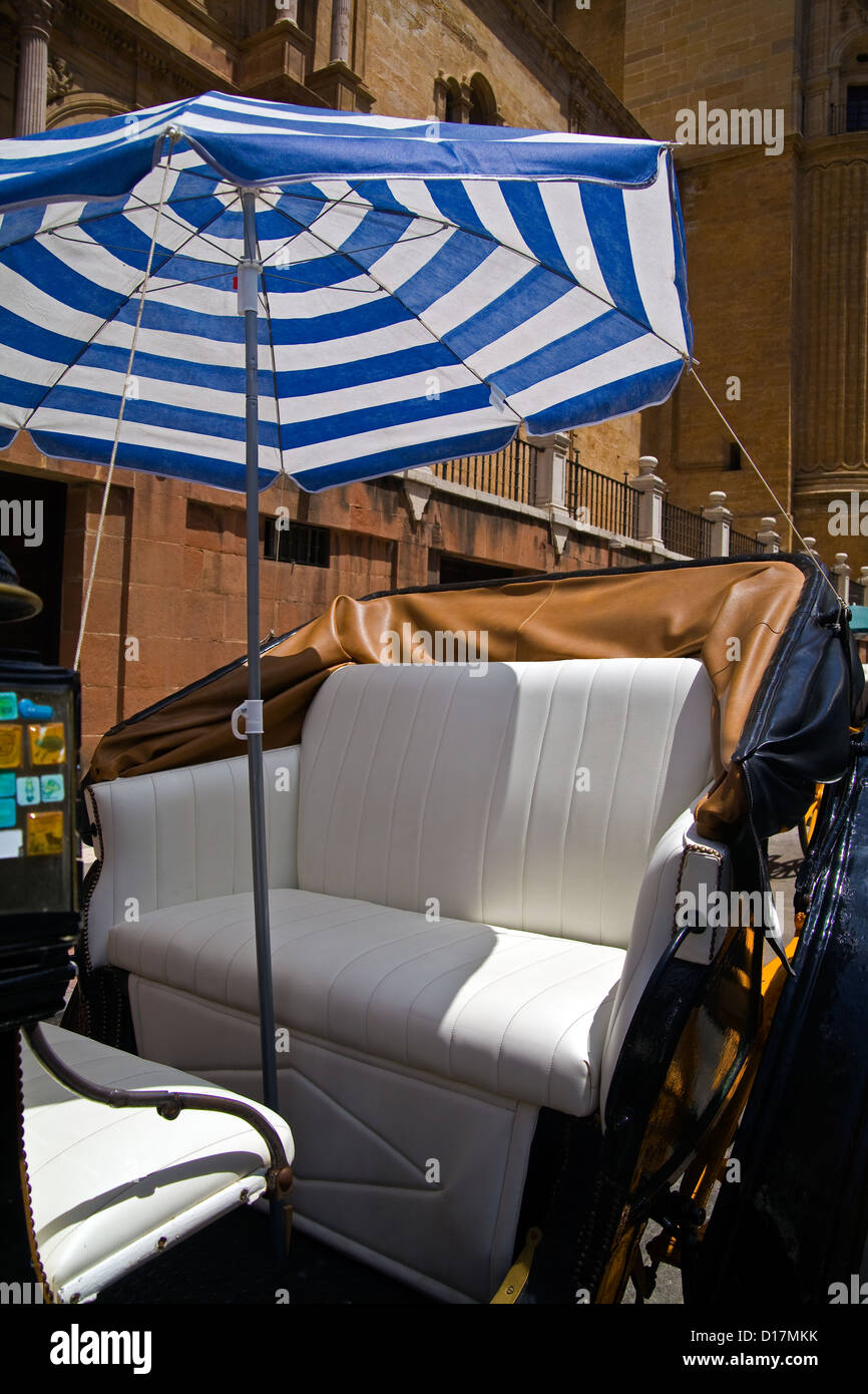 Seat and sunshade umbrella of a horse drawn carriage in Malaga, Andalucia, Spain Stock Photo