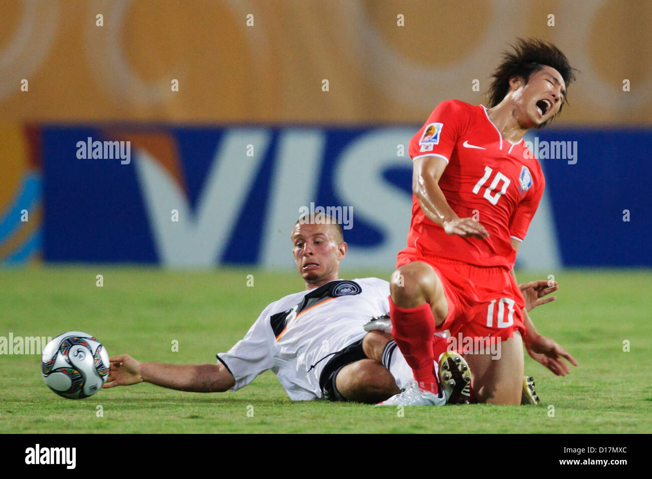 David Vrzogic of Germany (L) tackles Young Cheol Cho of South Korea (R) during a 2009 FIFA U-20 World Cup Group C match. Stock Photo