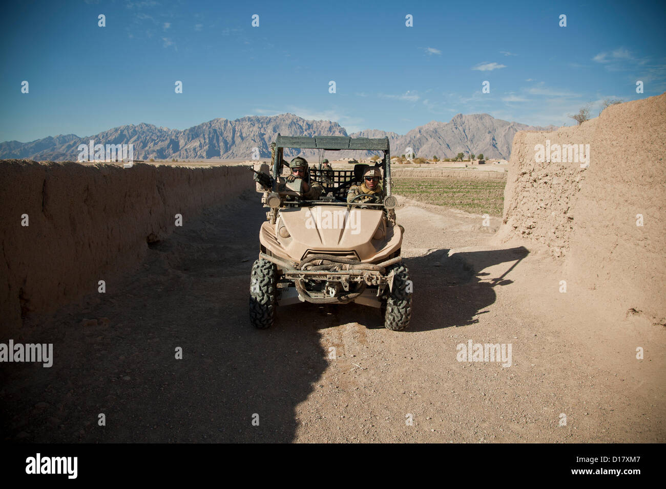 US Special Forces drive a light-tactical all-terrain vehicle through a village during a patrol December 9, 2012 in Farah province, Afghanistan. Stock Photo