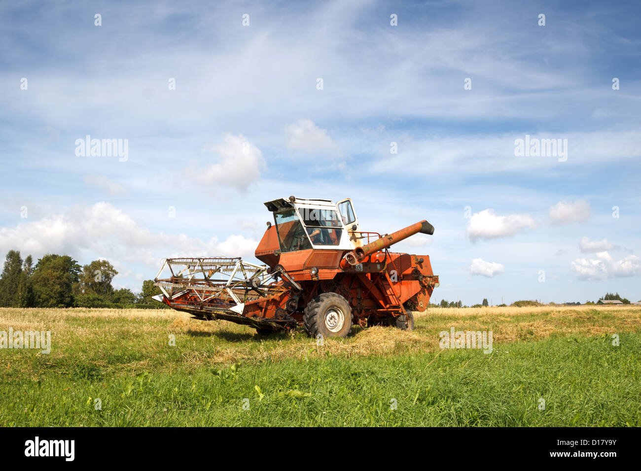 old grain harvester still working in the field Stock Photo - Alamy