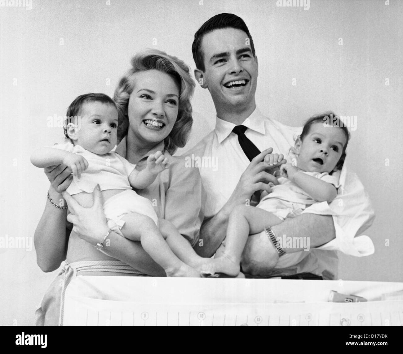 Portrait of happy family with baby twins Stock Photo