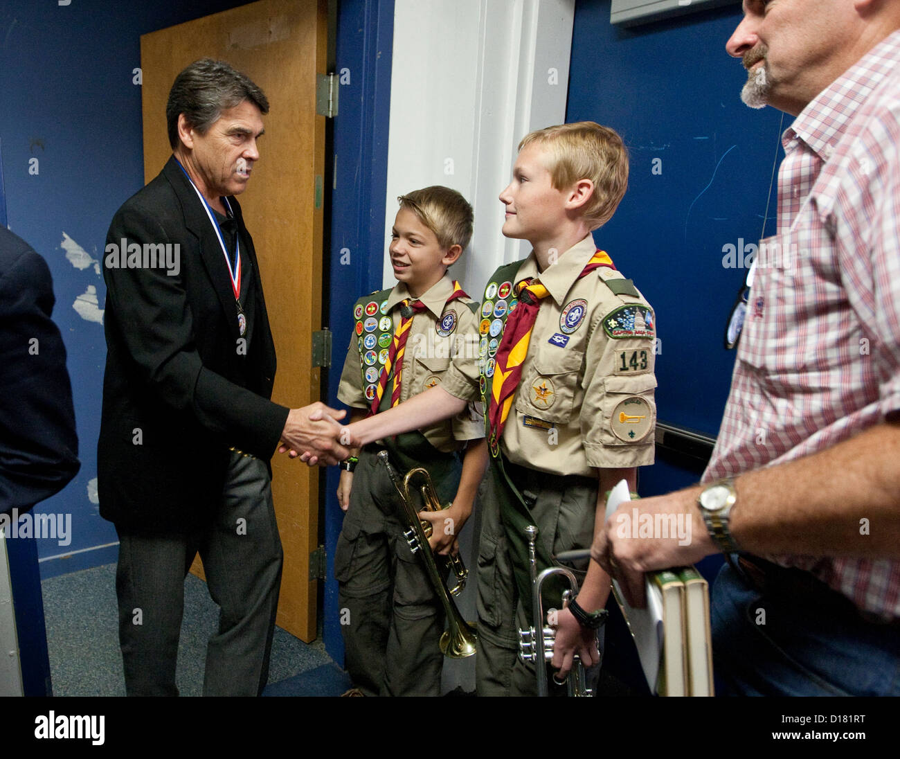 Texas Governor Rick Perry, greets young boy scouts at Veteran's Day celebration at Dime Box, Texas school. Stock Photo