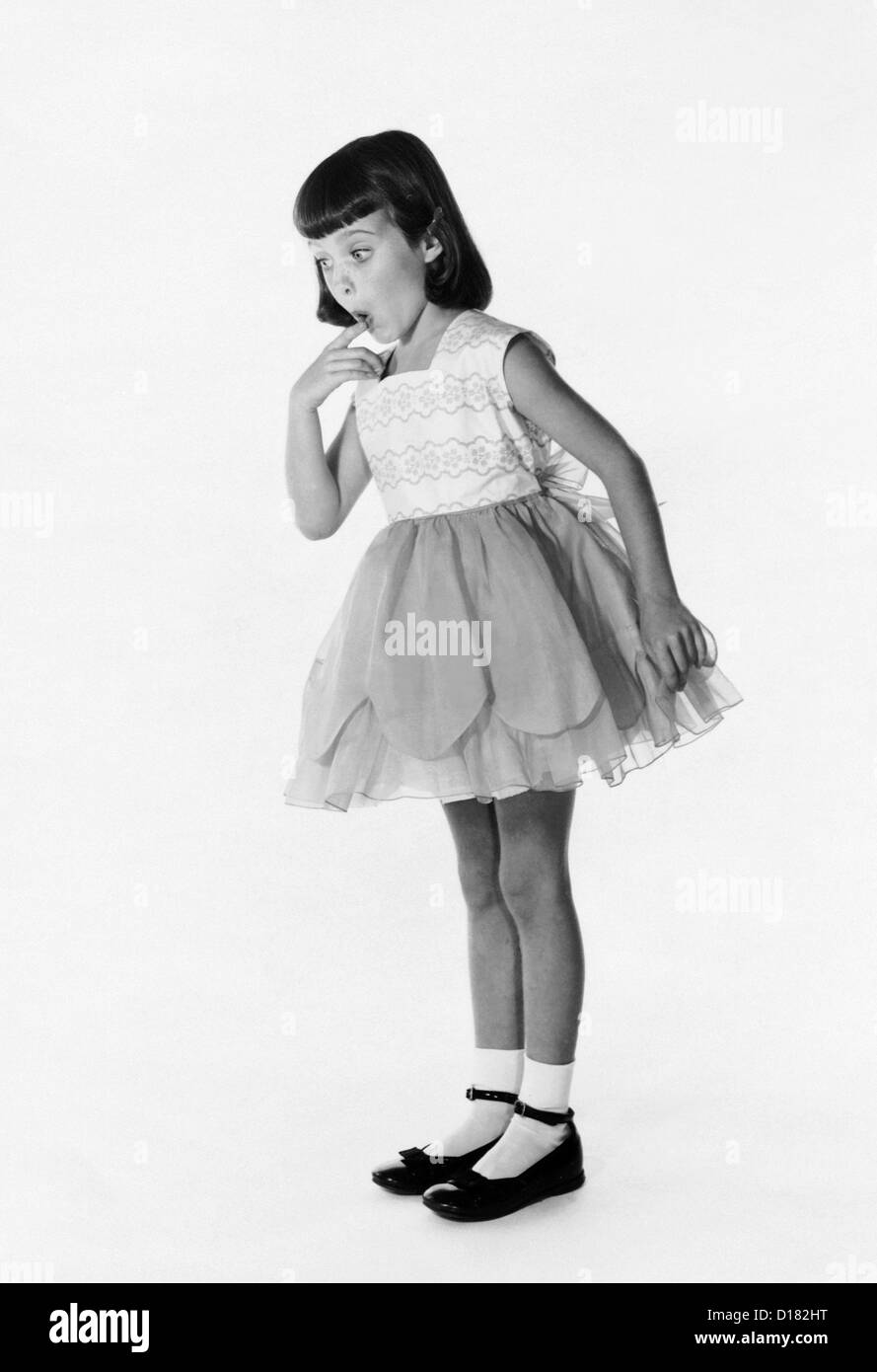 Little girl in dress with surprised expression Stock Photo