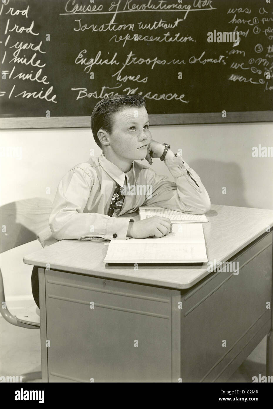 Historic image of boy daydreaming in class Stock Photo