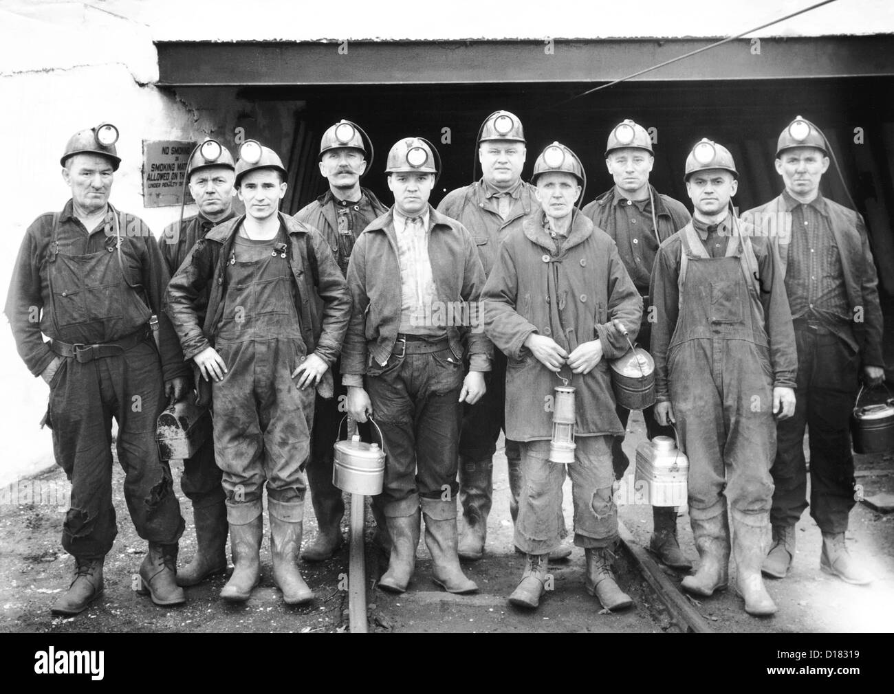 Coal miners at the entrance of a mine Stock Photo
