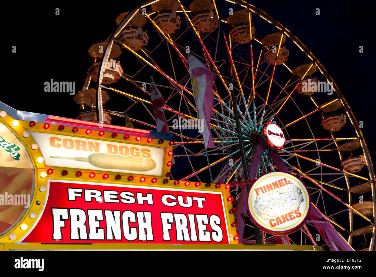 Colorful detail of a festive amusement park with food vendors lights
