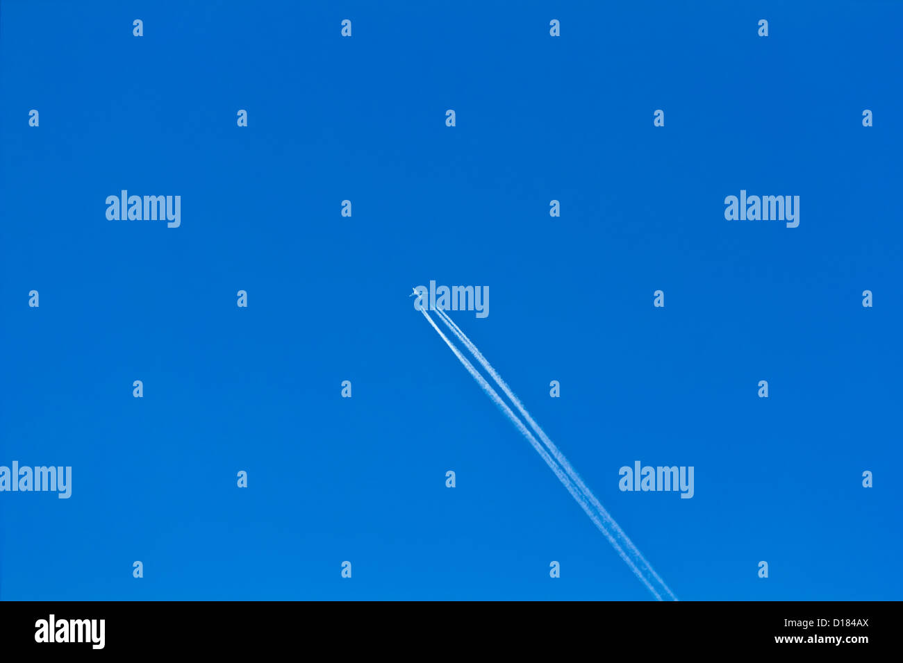Airplane flying in the blue sky Stock Photo - Alamy