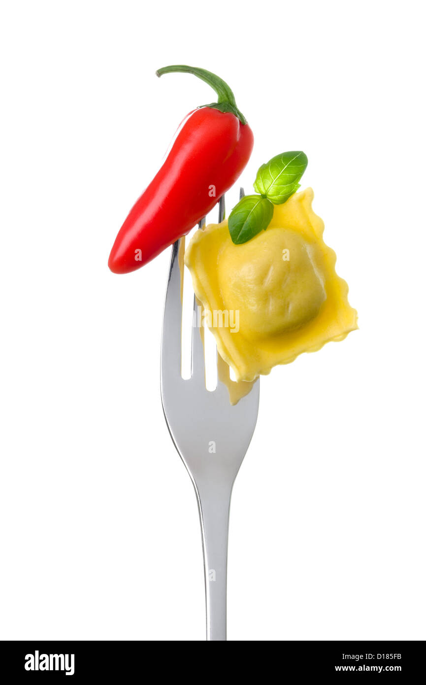 red hot chili pepper ravioli pasta and basil on a fork against white Stock Photo