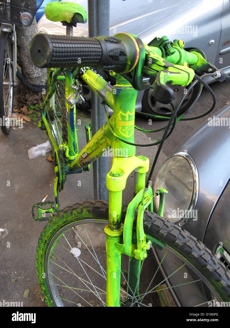 bike covered with bright green paint as anti theft system in street in rome italy Stock Photo