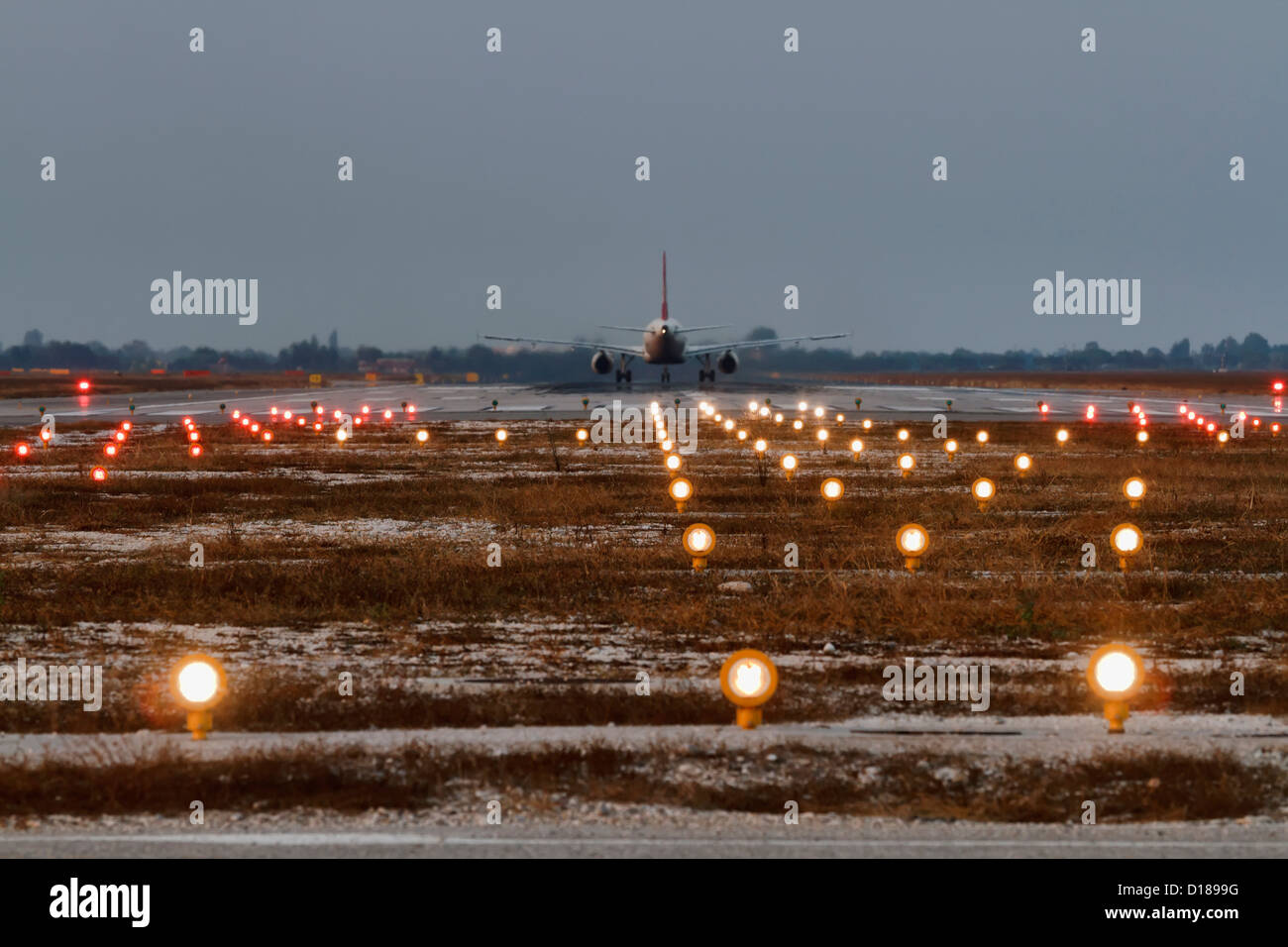 Italy, Venice International Airport, landing strip lights and aircraft ready for take-off Stock Photo