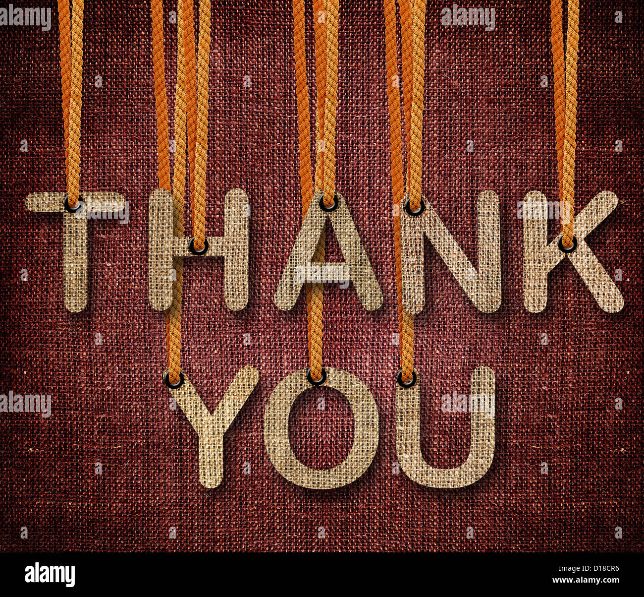 Thank you word hanging by rope as puppeteer on sackcloth background. Stock Photo